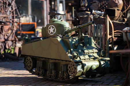 A small military model tank is showcased at an outdoor exhibition featuring vintage vehicles.の写真素材