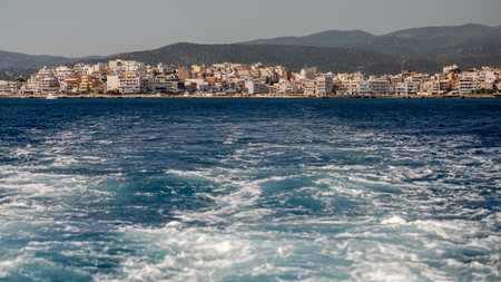 Colorful buildings line the shores of Agios Nikolaos, reflecting the charm of Crete's coast.の写真素材