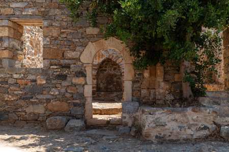 Explore the weathered stone structures and arches in the historic site of Spinalonga, Crete.の写真素材