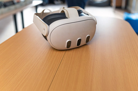 A virtual reality headset rests on a wooden table, ready for immersive experiences in gaming.の写真素材