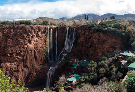 Majestic Ouzoud waterfalls cascading through rocky cliffs in Morocco's natural paradiseの写真素材