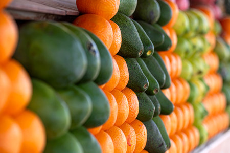 Vibrant display of oranges and avocados at a market in Marrakech, Moroccoの写真素材