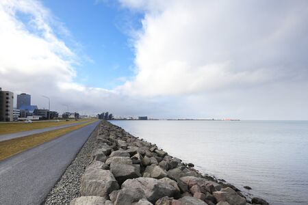 Embankment in Reykjavik, sunset over the ocean in Iceland, dramatic sky. Iceland.の写真素材