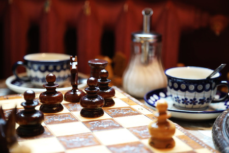 Chessboard on a coffee table on the background of morning light. Background.の写真素材
