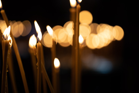Church candles on the background bokeh. Dark backgroundの写真素材