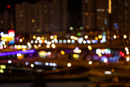 Drops of night rain on window, on back plan washed away lights of the cityの写真素材