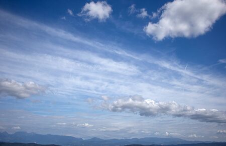 Blue sky with clouds beautiful mountains on background