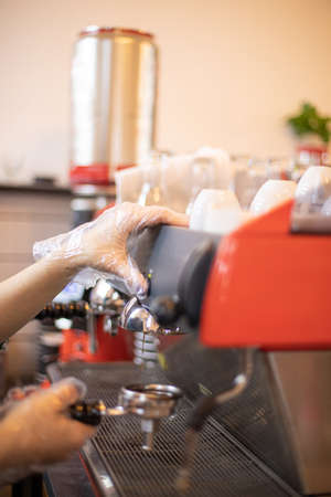 The hands of a barista brew cappuccino coffeeの写真素材