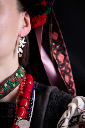 A girl in traditional Ukrainian clothing on black background