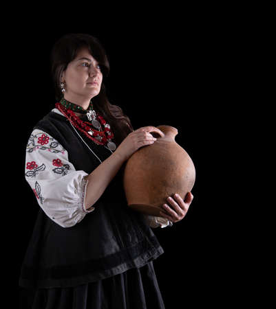 A girl in traditional Ukrainian clothing on black backgroundの写真素材