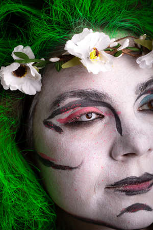A girl in the image of a witch with green hair on black backgroundの写真素材