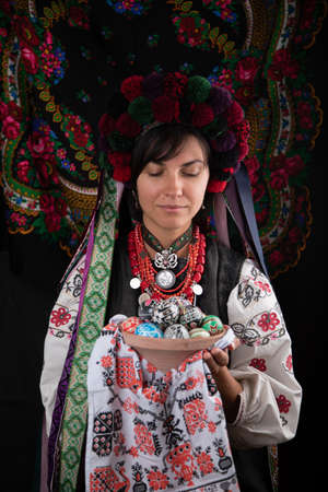 A beautiful Ukrainian woman in traditional clothes on dark background