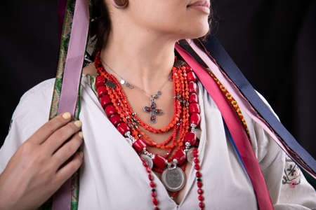 A beautiful Ukrainian woman in traditional clothes on dark backgroundの写真素材