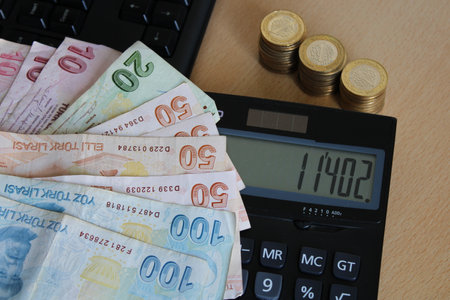 Turkish paper money above the calculator. It was designed for the Turkish minimum wage, tax and hike news.の写真素材