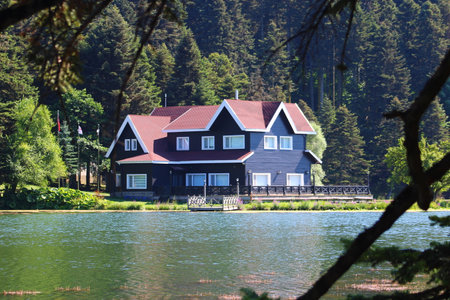 House on the shore of the lake. Reflected on water. Country side, forest, farm field, lake with house. Bolu, Turkey.の写真素材