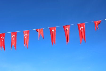 Turkish flags hanging on a rope on the street.の写真素材