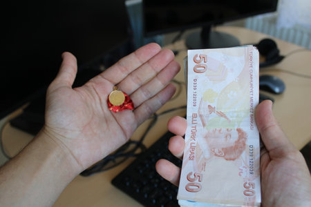 man counting Turkish banknotes with his hand.Calculator in the background. For tax and hike news....