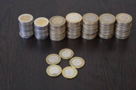 Turkish coins lined up on black background.