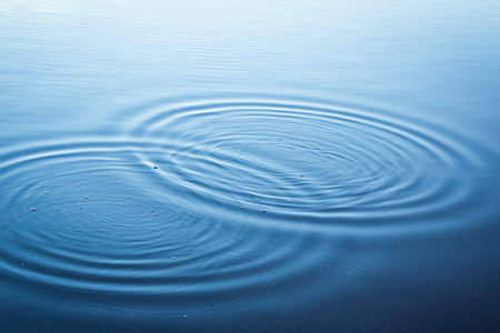 Round droplets of water over circles on the lake. Water drop, whirl and splash.Phone and laptop...