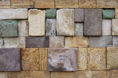 Close-up view of a wall made of several colored natural stones. decor harmony vision.