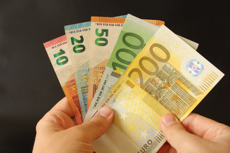 man counting euro money with his hand. euro banknotes. The paper currency of europan union...