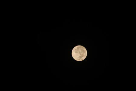 the full moon in the black sky