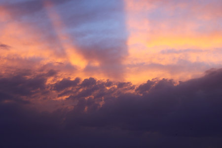 a sunset sky with clouds and a purple sky with a few clouds.