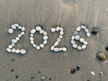 Pebble Art 2026 on the Beach Sand. 2026 new year concept
