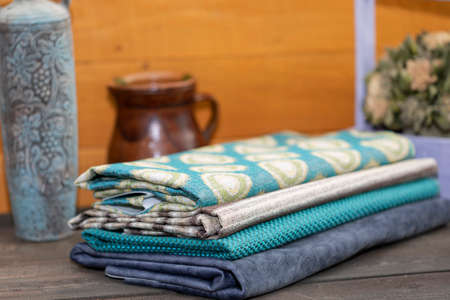 Fabrics with ceramic vases and a wooden box with dried flowers on a wooden backgroundの写真素材