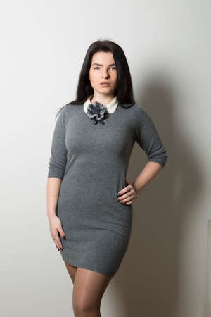 Girl in a gray knitted dress withの写真素材