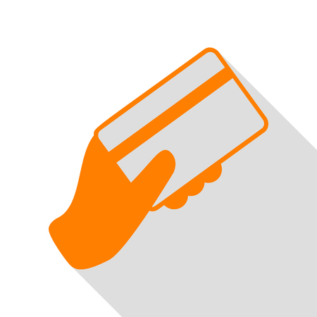 Hand holding a credit card. Orange icon with flat style shadow path.のイラスト素材