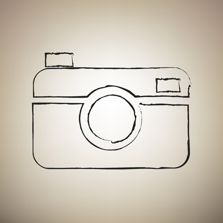 Digital photo camera sign. Vector. Brush drawed black icon at light brown background.のイラスト素材