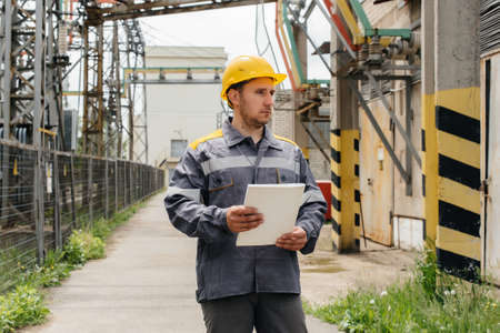 The energy engineer inspects the equipment of the substation. Power engineering. Industry