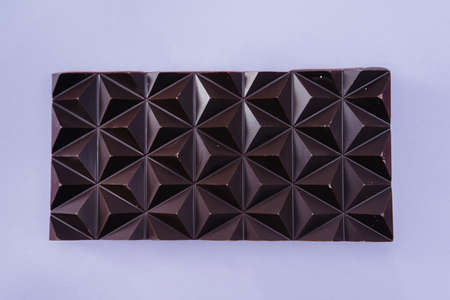 Natural handmade chocolate close-up on a bright background.