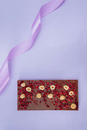 Natural handmade chocolate close-up on a bright background.