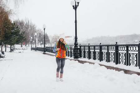 A beautiful young girl is Jogging on a frosty and snowy day. Sports, healthy lifestyleの写真素材