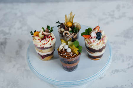 Set of beautiful delicious trifl close - up on the background. Dessert and sweets