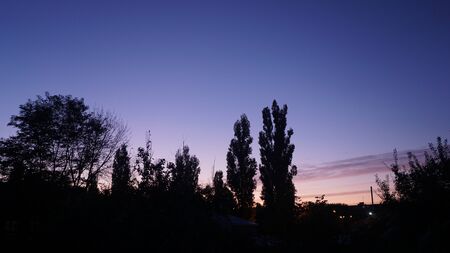 purple sky colors and orange dawn at sunrise over the city of Yeiskの写真素材