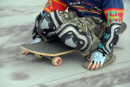 Young teen uses skateboard ramp at parkの写真素材