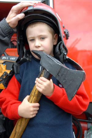 A young boy sitting in a fire truckの写真素材