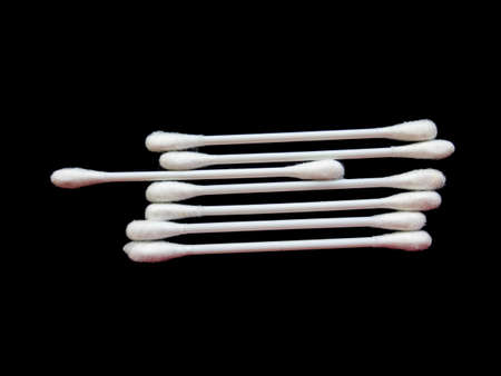 Cotton buds isolated on black backgroundの写真素材