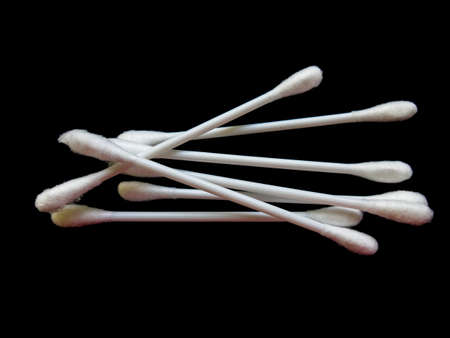 Cotton buds isolated on black backgroundの写真素材