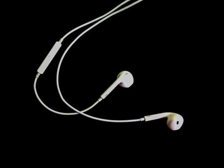 white earphones isolated on black backgroundの写真素材