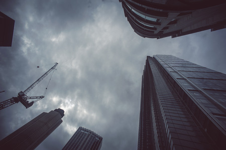 Skyscapers from below with dramatic skyの写真素材