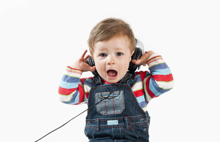 Baby with headphone,isolated on a white background の写真素材