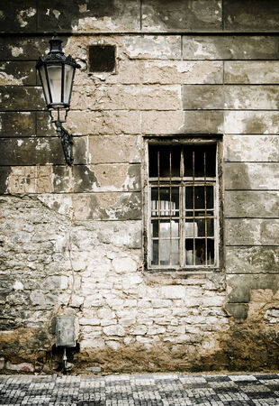 Old brick ruin wall in prague with window, and candelabras. の写真素材