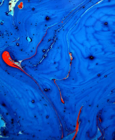 Photographs of Splash paint.Closeup abstract color mixing of water, acrylic,oil and milk for use as...