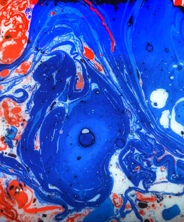 Closeup abstract color mixing of water, acrylic,oil and milk for use as background image. Acrylic texture with beautiful pattern, multi color background photo.の写真素材