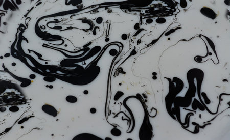 Black and white ink mixing in water. Abstract background of acrylic paint.の写真素材
