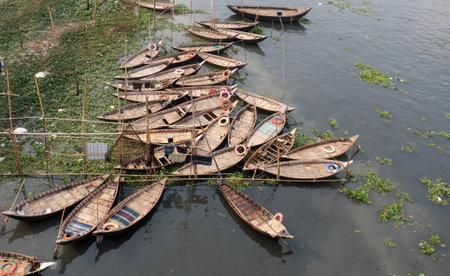 Traditional wooden boats on the buriganga River in dhaka. The buriganga River is one of the largest river.The floating market in the Buriganga river near dhaka city in Bangladeshの写真素材